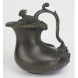 A 19th century bronze jug, of gourd shape outline the rim surmounted by two goats, with scroll