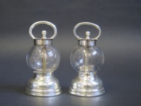 A pair of glass and silver mounted salt and pepper mills, the ops by Hukin & Heath, 1903/05, the