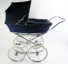 A Marmet child's pram, with hinged hood, mounted with spoked wheels and solid rubber tyres.