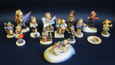 A collection of twelve Hummel figures including school children skier, Hikers, together with a