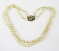 A Graduated Pearl or Cultured Pearl Twin Strand Necklace with 9ct clasp, 17.25" (44cm), largest