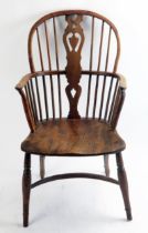 A late 18th century elm Windsor style elbow chair, the arch back with central shaped splat having