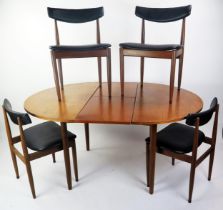 A 1970's G-Plan teak extending dining table with integral folding leaf, raised on turned legs, 150cm