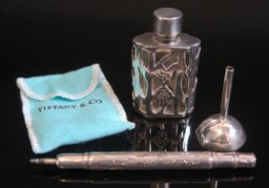 A clear glass and silver mounted scent bottle 5.5cm high, together with a white metal funnel