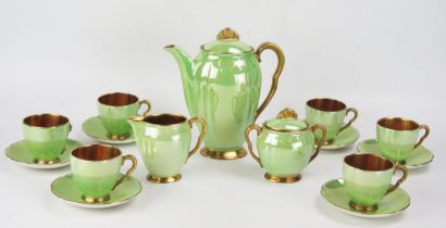 A Carlton ware coffee service, with pea green lustre glaze bordered in gilt, includes six cups , six