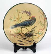 A Diaz Costa pottery plate, decorated with an exotic bird amongst shrubs, monogrammed CD, 21cm