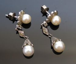 A Pair of Cultured Pearl and Diamond Pendant Earrings in a precious white metal setting, 38mm