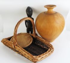 An African carved wood fertility figure, 28cm high, a wood vase, wicker basket and a circular