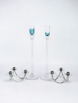 A pair of Danish stainless steel three light candlesticks, together with a pair of Scandinavian