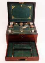 A Victorian mahogany travelling vanity box, the hinged lid enclosing a fitted interior of silver