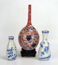 A Japanese Imari porcelain bottle vase, of ovoid form with slender neck, with all over floral