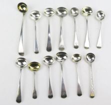 A collection of fourteen assorted Old English pattern silver mustard spoons, various makers and