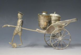 A Chinese white metal condiment stand in the form of a rickshaw, with three condiments, 167gms, 5,