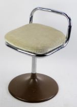 A 1970's Chair Centre tubular chrome swivel low chair, with padded seat on a circular base.