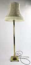 A lacquered brass Corinthian column standard lamp on a reeded column and square base raised on paw