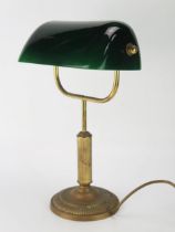 An anodised metal banker's table lamp with green glass shade on a reeded column and circular