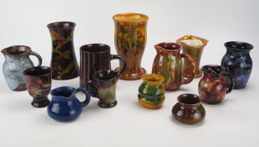 A collection of assorted Ewenny pottery wares including vases and jugs, various sizes and glazes.