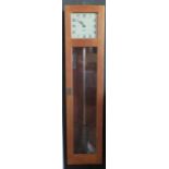 A GENTS master clock contained in an oak case, with pendulum, 127cm high
