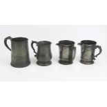 Two 19th century pewter mugs 15cm and 12cm high, together with two pewter jugs both 12.5cm high. (