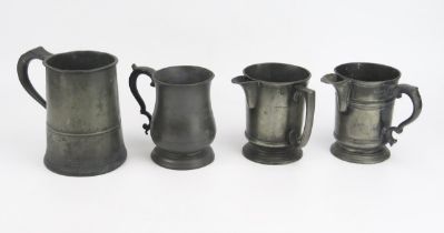 Two 19th century pewter mugs 15cm and 12cm high, together with two pewter jugs both 12.5cm high. (
