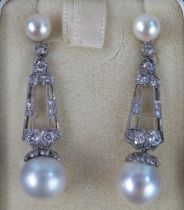 A Large Pair of Cultured Pearl and Diamond Drop Pendant Earrings in a precious white metal