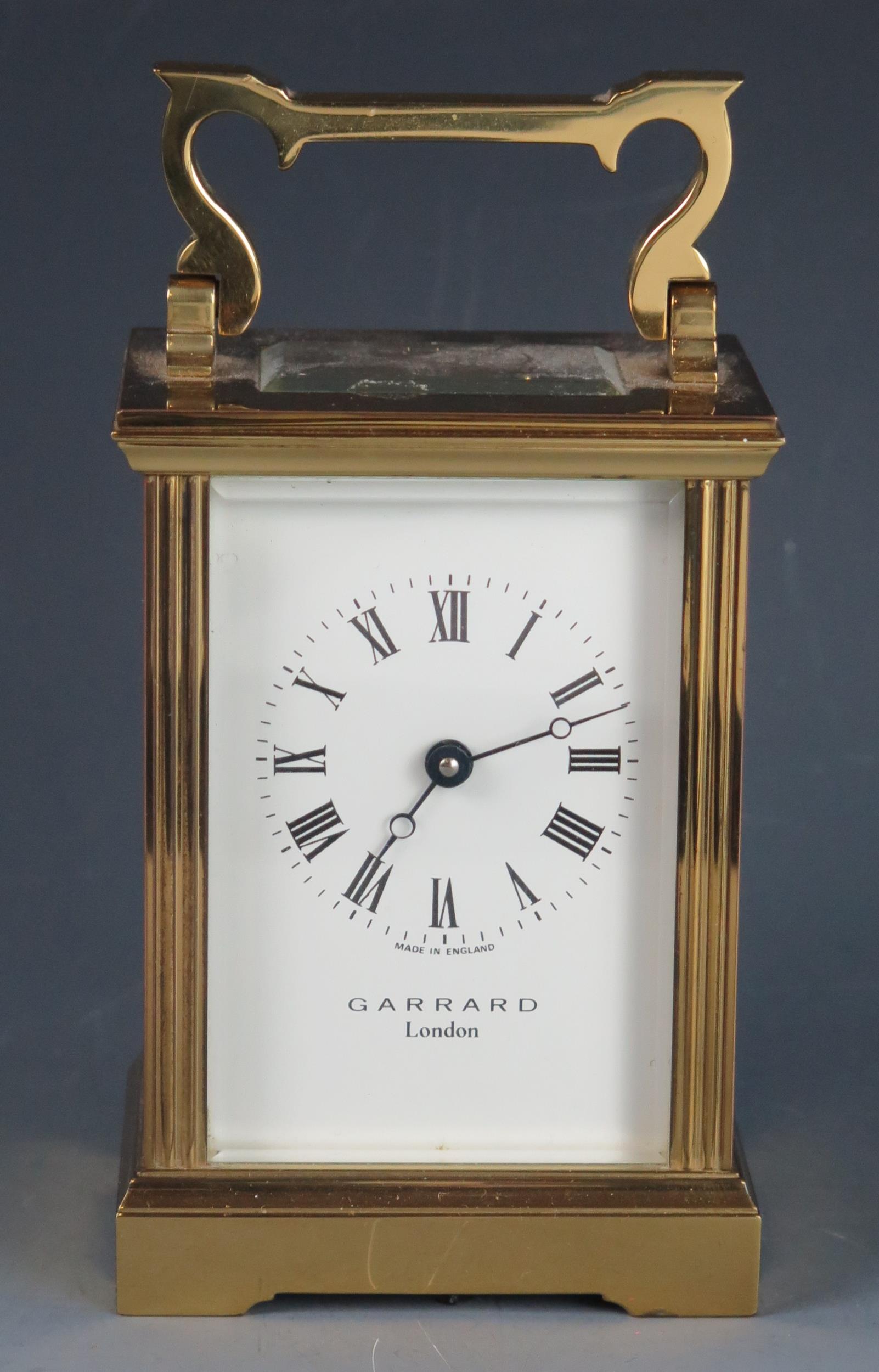 An English lacquered brass carriage timepiece, the 6cm Arabic dial signed Garrard, London, the