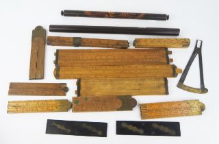 A collection of folding rulers, slide rules, rolling rulers, etc.