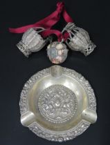 An Asian white metal ashtray, 11cm diameter, a pair of white metal wire work baskets, 6.5cm high,