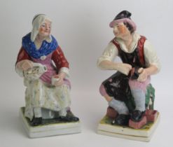 A pair of Staffordshire pottery figures 'The Cobbler and His Wife', 31cm high