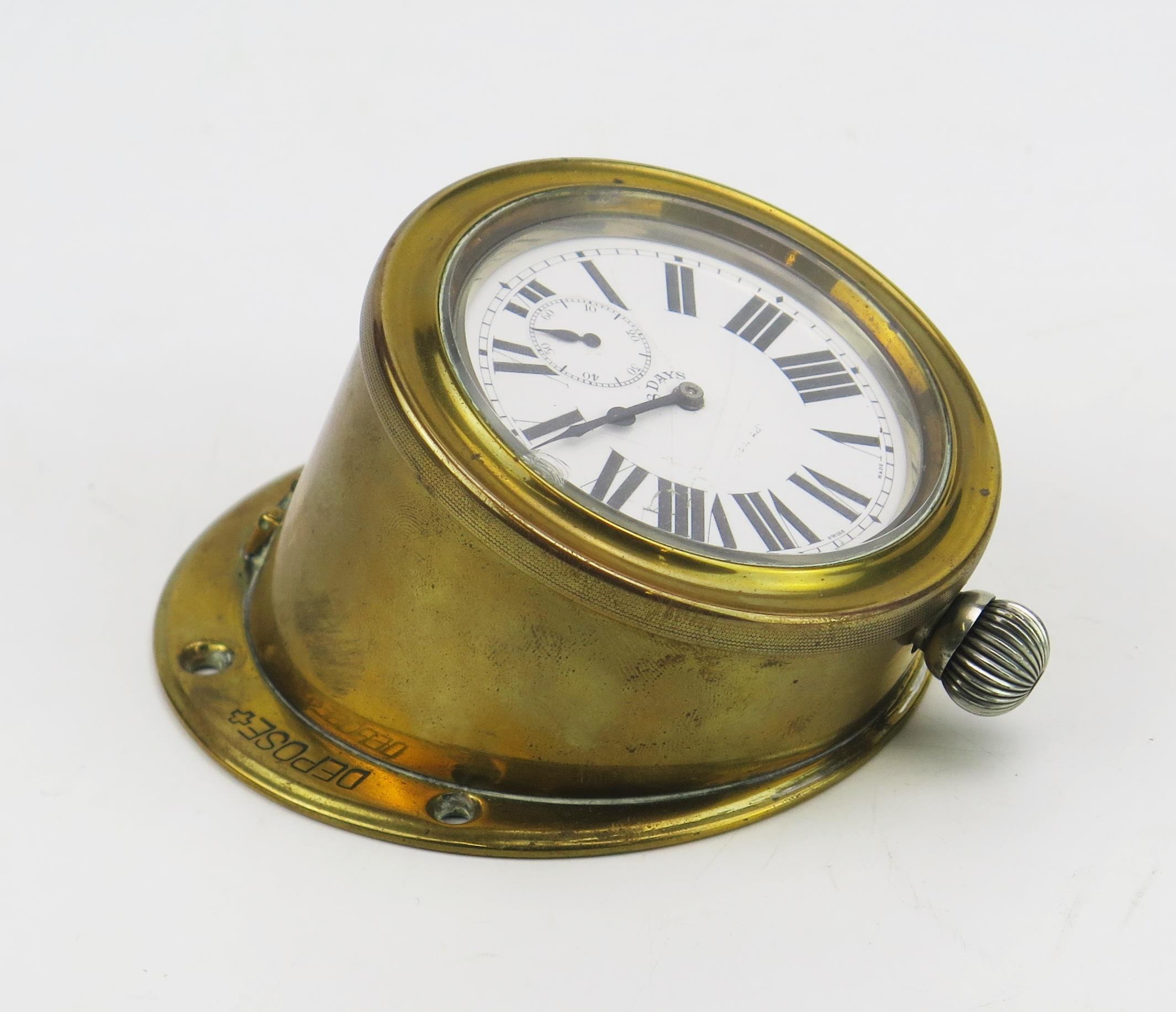 A French brass cased dashboard timepiece, the eight day movement with 6cm Roman dial and