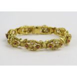 A 1950's 18ct Gold, Ruby and Diamond Bracelet decorated with eight panels having stones in