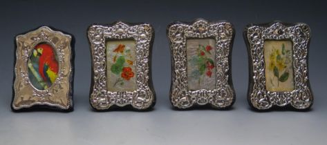 Three near matching miniature silver easel photograph frames, and another photograph frame various