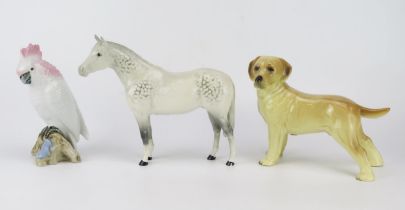 A Beswick dapple stallion, gloss glaze, 23cm long, a continental porcelain figure of a parrot and