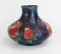 A Moorcroft pottery vase, of squat globular form, decorated in the 'Finches' pattern designed by