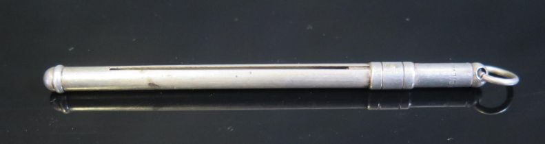 An Art Deco period sterling silver swizzle stick, stamped sterling, with sliding action.