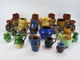 A collection of Denby Cadbury's Chocolate jugs, together with other vases, cream jugs, sugar basins,