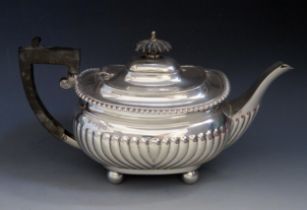 A George V silver teapot, maker Barker Brothers, Chester, 1917, of barge-shaped outline, with