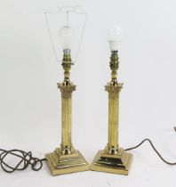 A pair of lacquered brass Corinthian column table lamps, on stepped square bases.