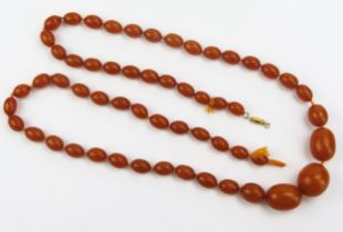 A Pressed Amber Graduated Bead Necklace, largest 27.7x24.5mm, second largest 28.3x21.5mm, 39" (