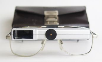 A pair of Ocutech VES magnifying glasses, with stitched leather case.