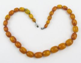 A Graduated Amber Bead Necklace, 17.6x13.7mm largest bead, 16.5" (42cm), 32.2g