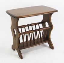 An Ercol magazine rack, with rectangular top on trestle end supports with turned spindle rack, 54.
