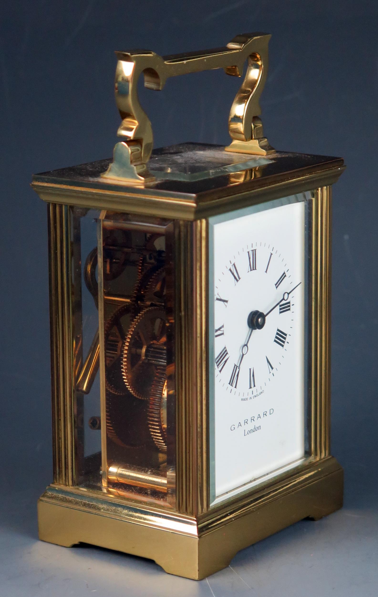 An English lacquered brass carriage timepiece, the 6cm Arabic dial signed Garrard, London, the - Bild 2 aus 3