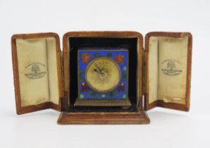 A 20th century French cloisonné travelling timepiece, the square case with 3cm circular brass