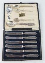 A set of six silver handled butter knives, filled, cased, a late Victorian silver caddy spoon, and