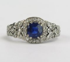 A Pretty Sapphire and Old Cut Diamond Ring with pierced foliate shoulders and diamond set around the