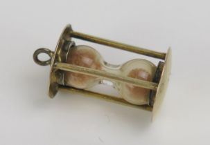 A 9ct Gold 'Hour Glass' Charm, stamped 9CT, early 20th century, 1.75g