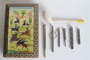 Three propelling pencils, two lead holders, a clay pipe with Irish harp decoration, and a Sadeli