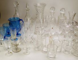 An extensive collection of assorted glass wares including decanters, wine glasses, fruit bowl