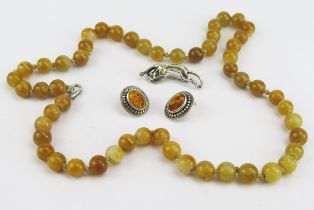 A White Metal Panther Brooch, a pair of silver and amber earrings and a hardstone bead necklace